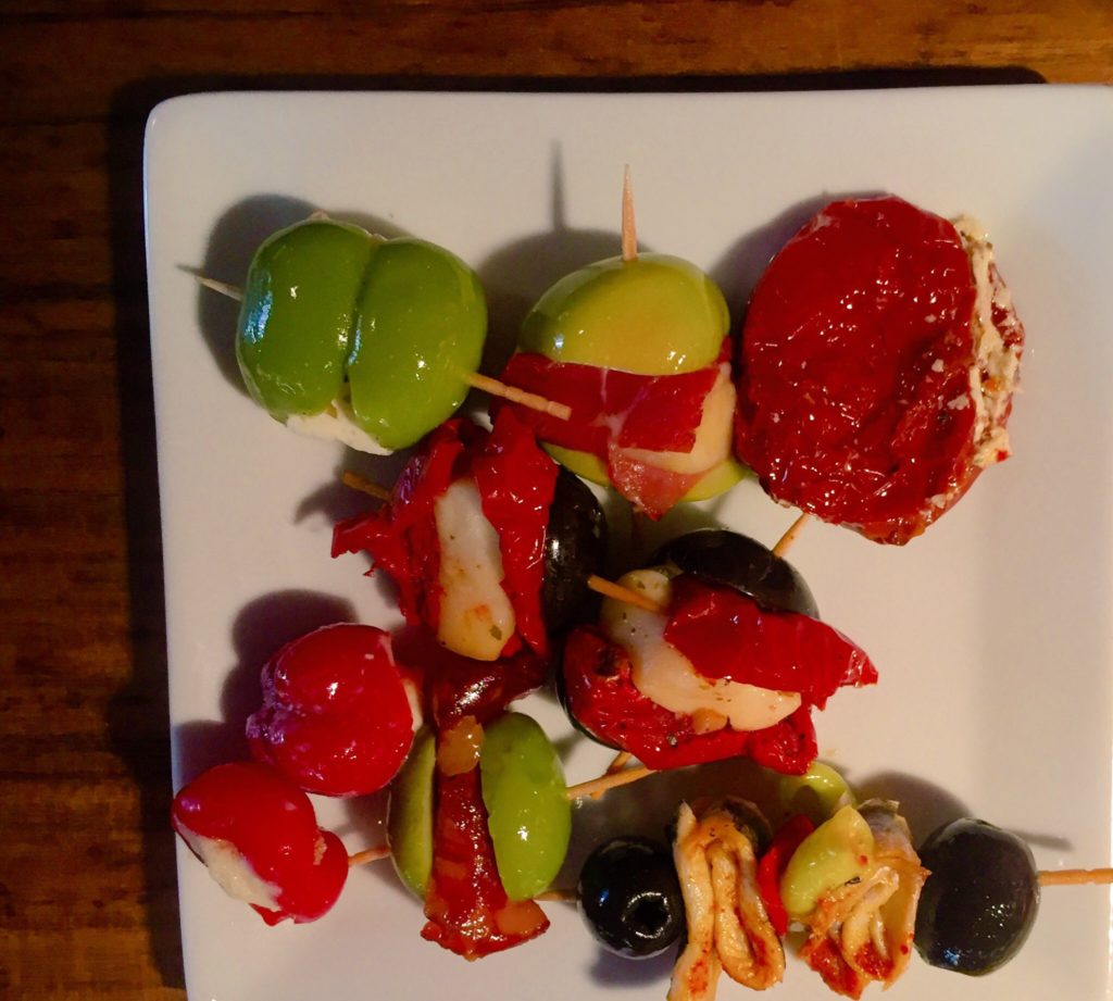 olives and pickled peppers stuffed with cheese at a food market in madrid