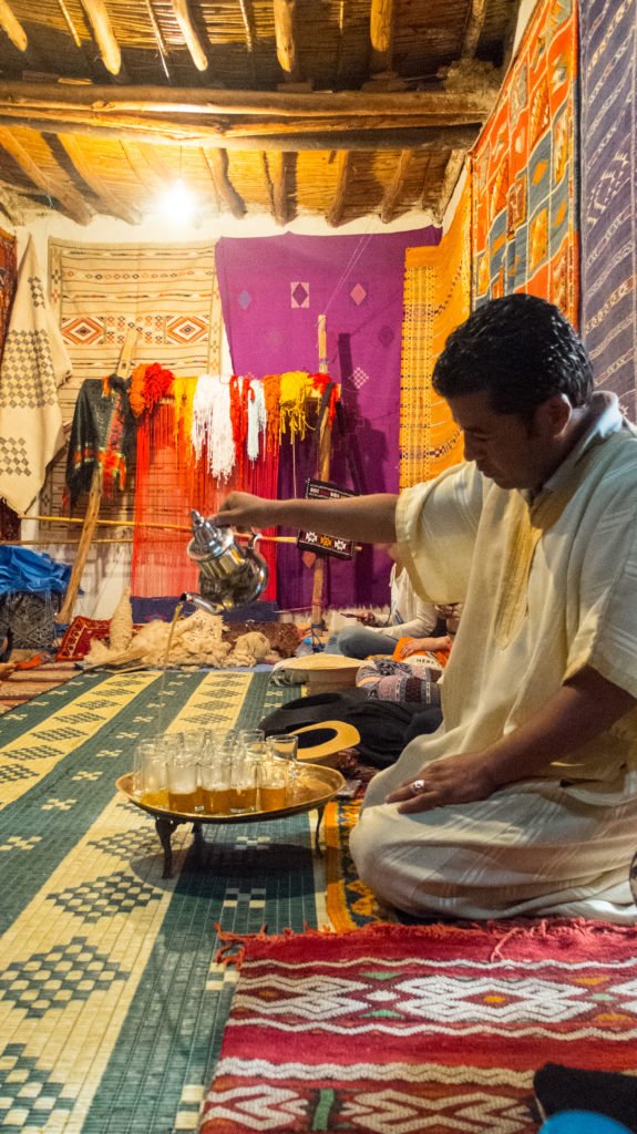 A man pouring mint tea at a rug shop