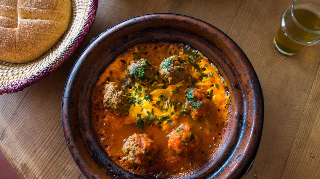 a dish of meatballs served with bread in a tagine