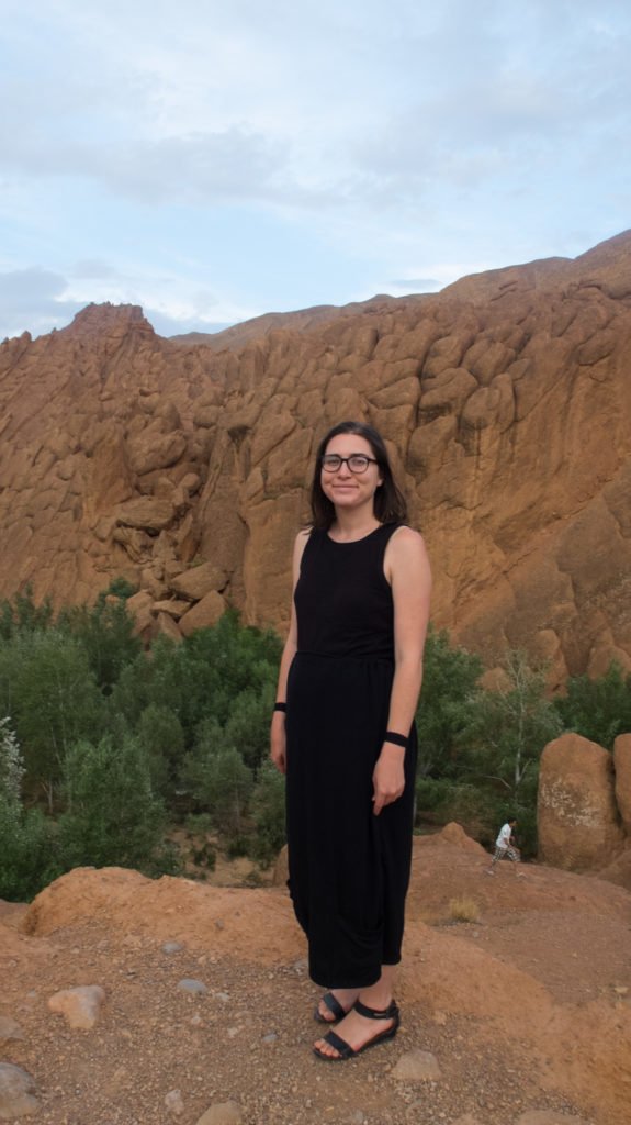 Allison, the author of the article, standing with a dress with matching seasickness bands and shoes