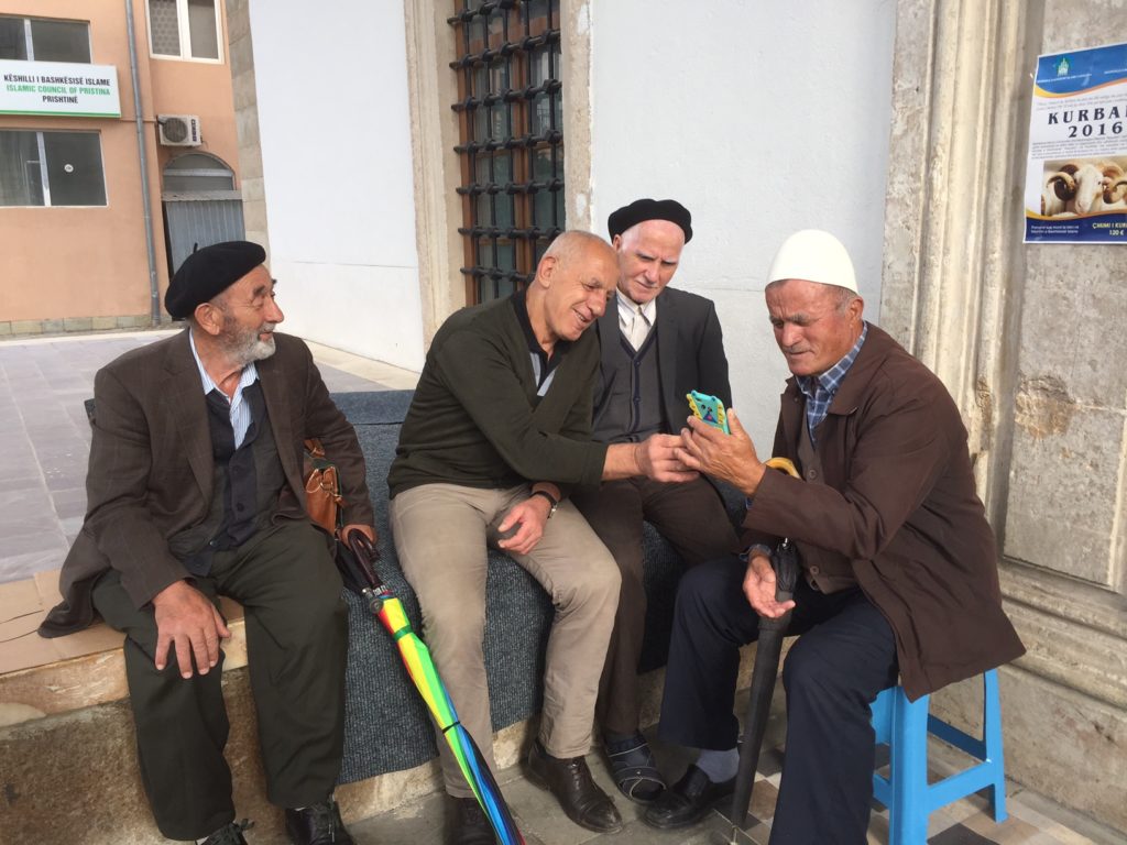 A group of friendly locals outside of a mosque in Kosovo