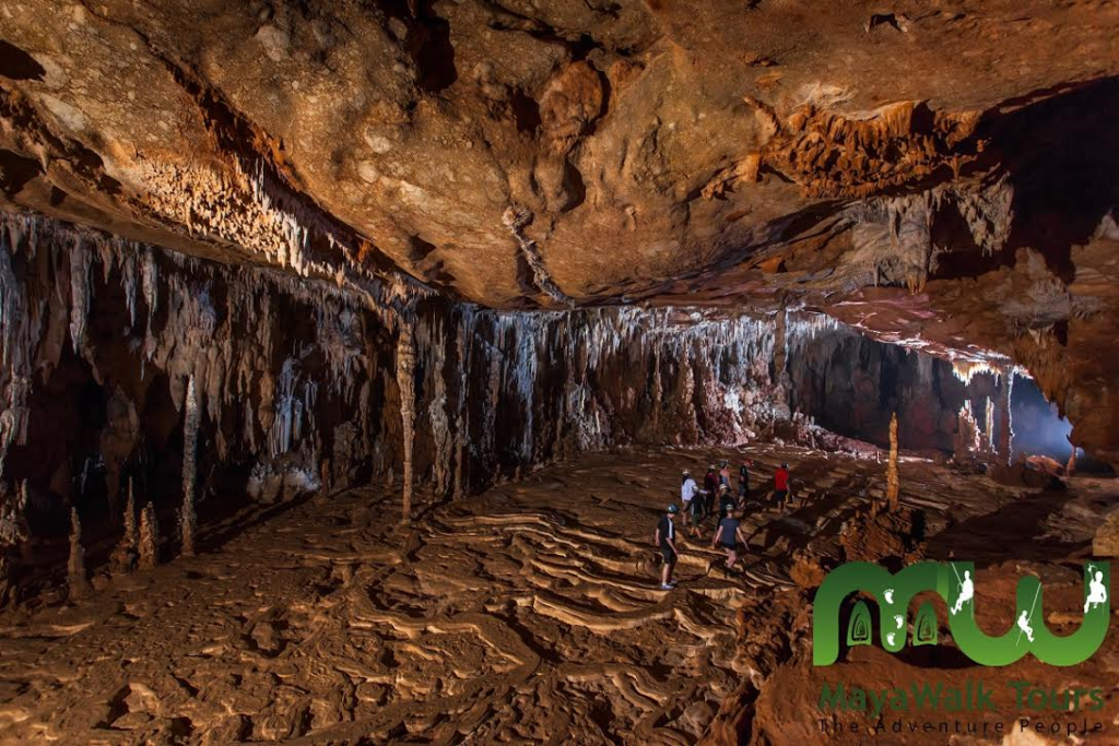 People walking inside the main atrium with huge crystals in the ATM cave in belize