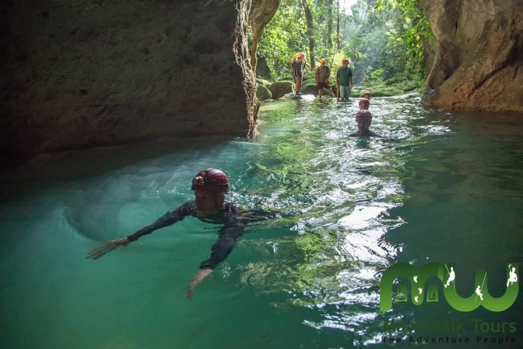 people swimming in the cave in the atm cave tour