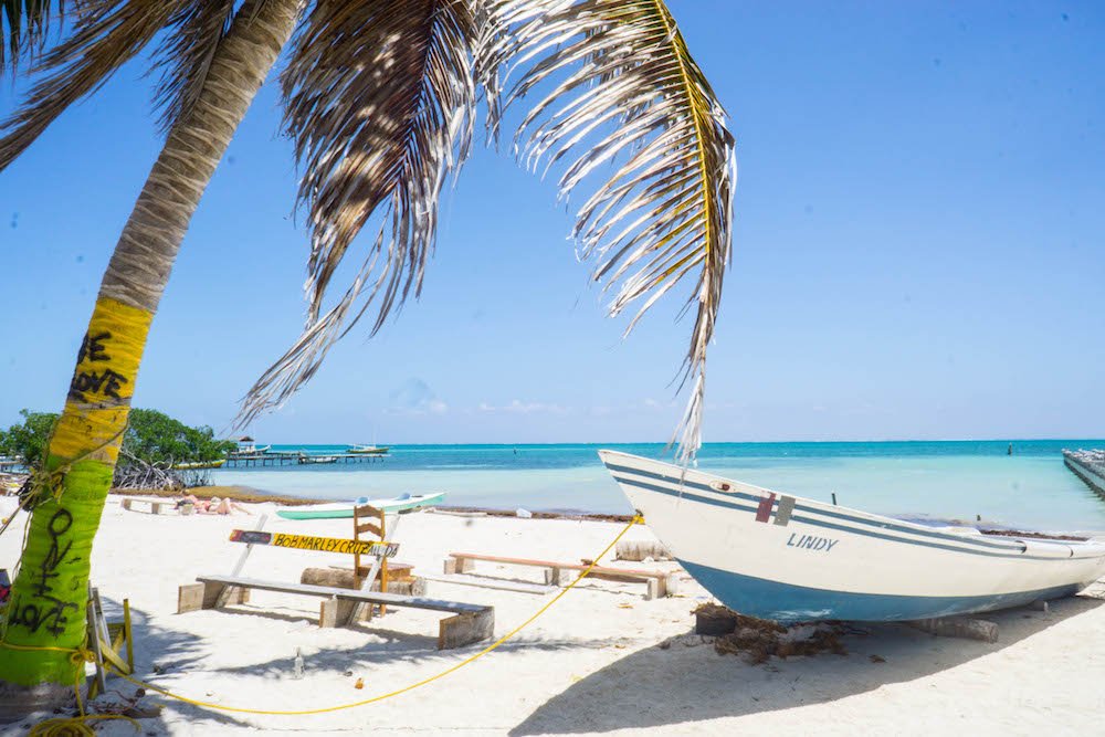 Paradise views are everywhere in Caye Caulker, like this beach scene with a boat