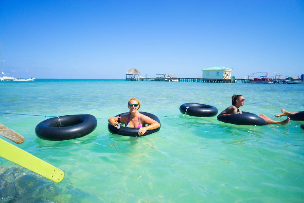 Allison Gren's friend Janet drinking a beer in an inner tube