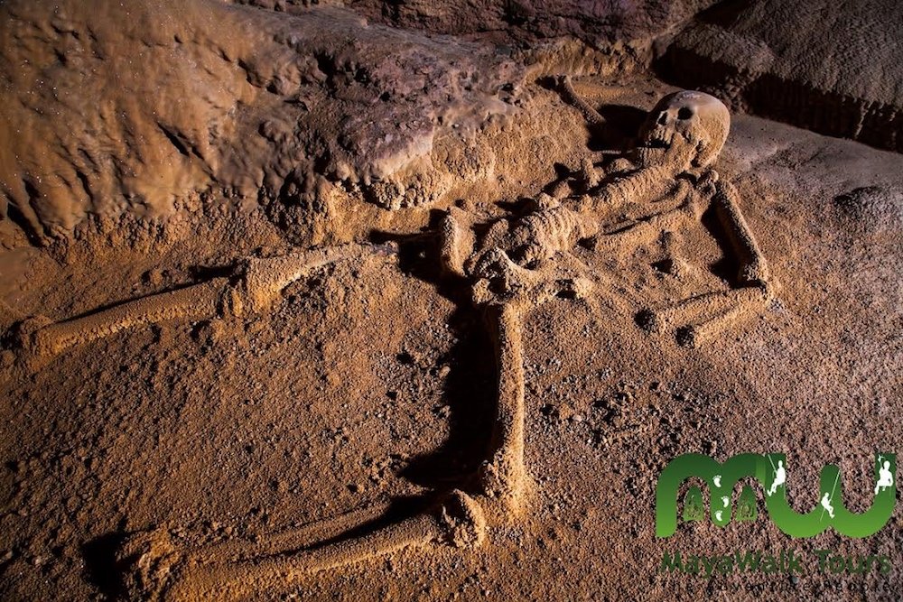 Remains of a human skeleton in the ATM cave at the end of the tour, with crystallized formations