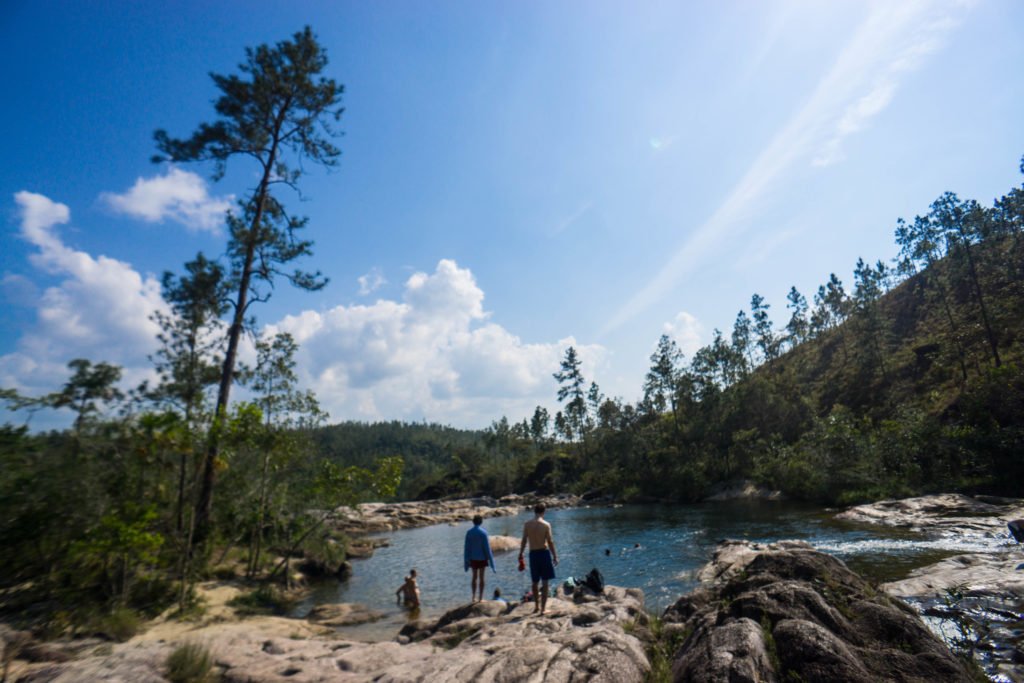 The rio on pools outside of Caracol belize with people enjoying the waters in the distance