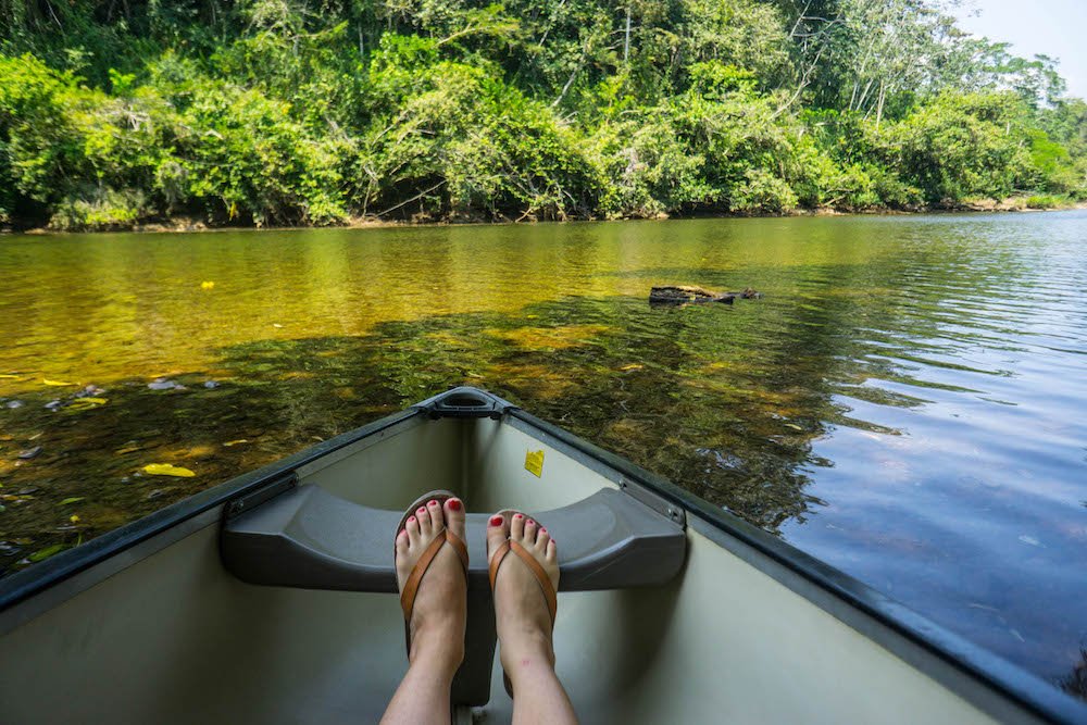 Allison Green with her feet in a canoe in the river