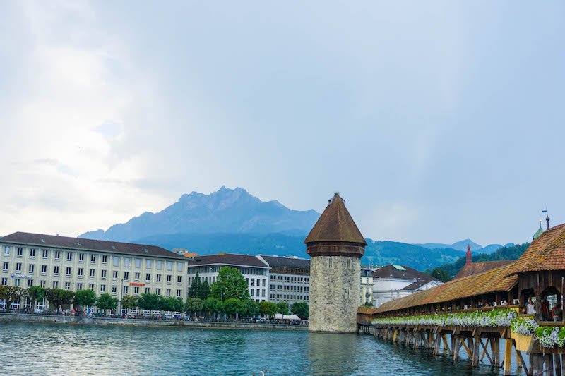 The Chapel Bridge (Kapelbrucke) of Lucerne, Switzerland on a partly cloudy day in summer.