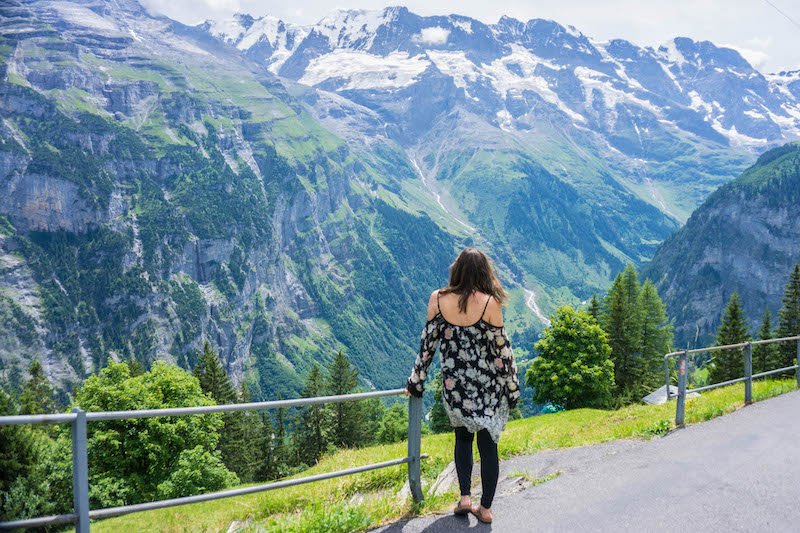 Allison Green in Switzerland in summer in a dress and leggings