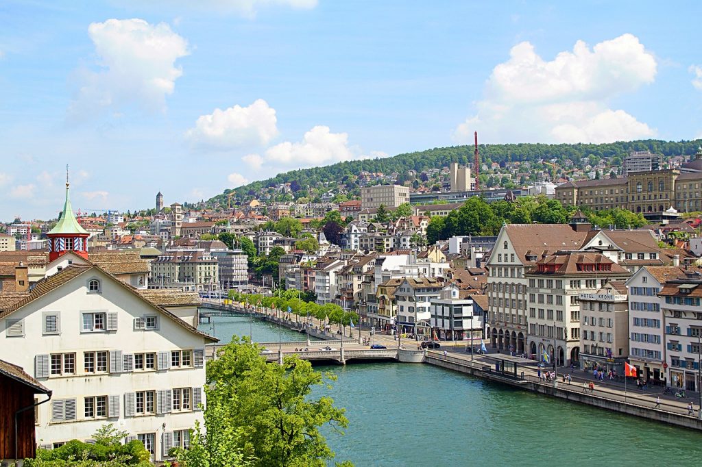 the city of zurich with bridges, a beautiful river, and lots of gorgeous buildings and churches