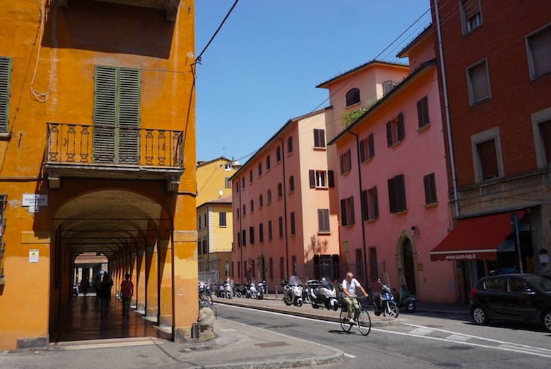 Bologna porticos and buildings and bicyclist