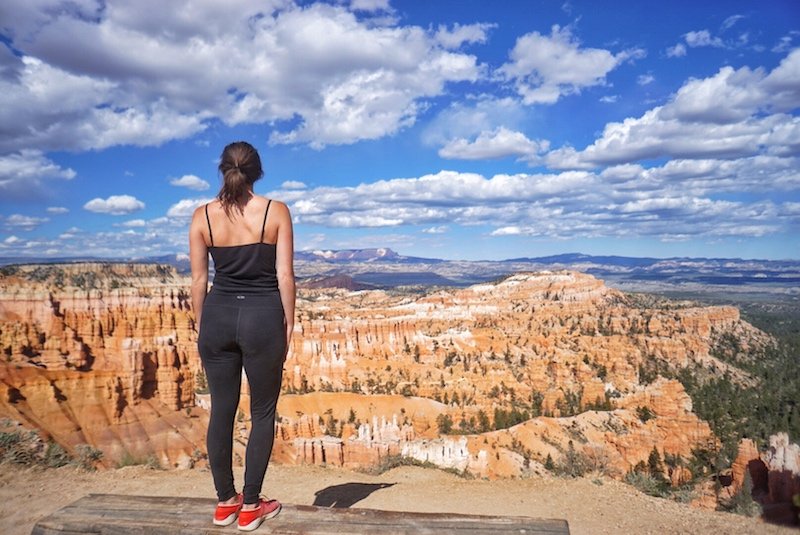 allison looking over the edge of bryce canyon and its orange hoodoos