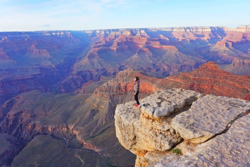 Allison standing at the South rim of the grand canyon