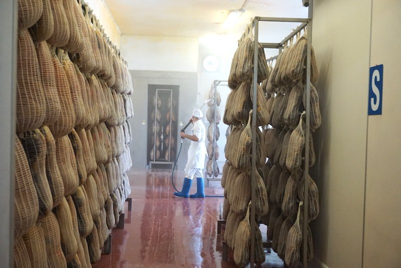 man in prosciutto factory