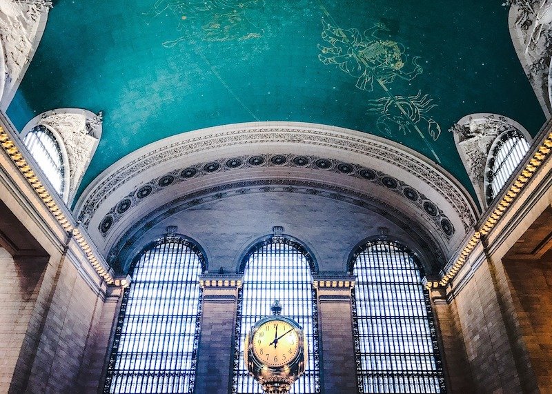 constellation-themed ceiling of the grand central station with its famous clock and teal painted ceiling