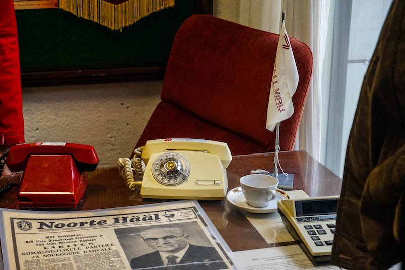 View inside the KGB museum of Tallinn with a phone, chair, and other artifacts from when this hotel housed KGB offices from the Soviet Union