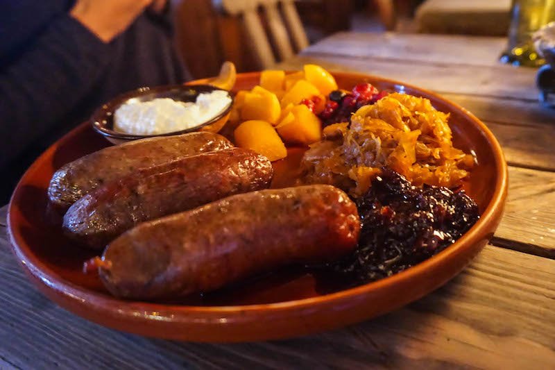 Boar and bear sausages and other side dishes at the medieval restaurant in old town tallinn in winter