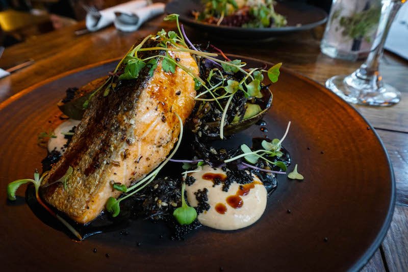 A salmon dish in a popular restaurant in Estonia with unique Japanese flavors like tobiko fish egg and kewpie mayo