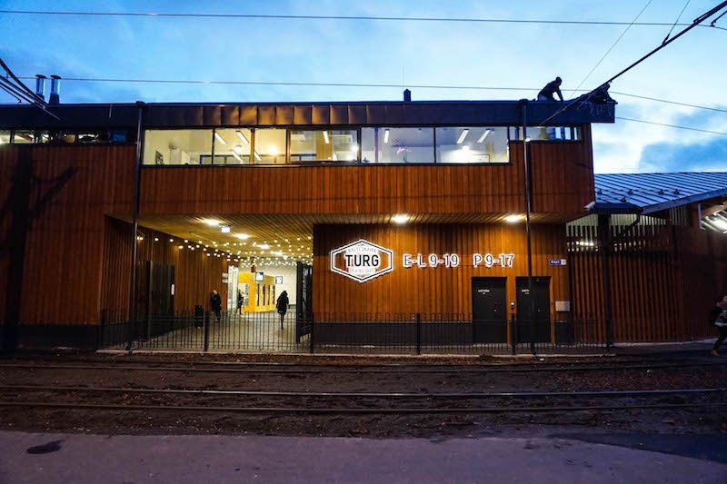 The lit up Balti Jaam market in Estonia after the sun has set over the city, a converted green market