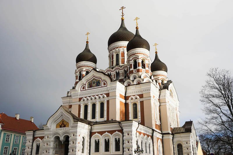 The Alexander Nevsky Russian orthodox cathedral in Tallinn with its peach colored onion domes on a cloudy day