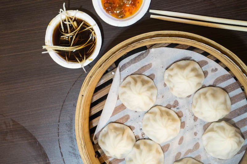 delicious dumplings, steamed, with soy sauce and ginger and chili oil on the side