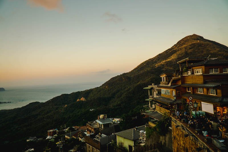 The famous teahouses of Jiufen with Mount Keelung in the distance and the beautiful coastline of Taiwan