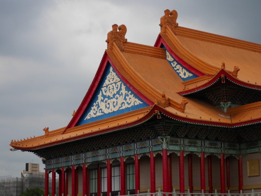 detail of one of the buildings in the taipei downtown area in the memorial hall, with red pillars and blue detail