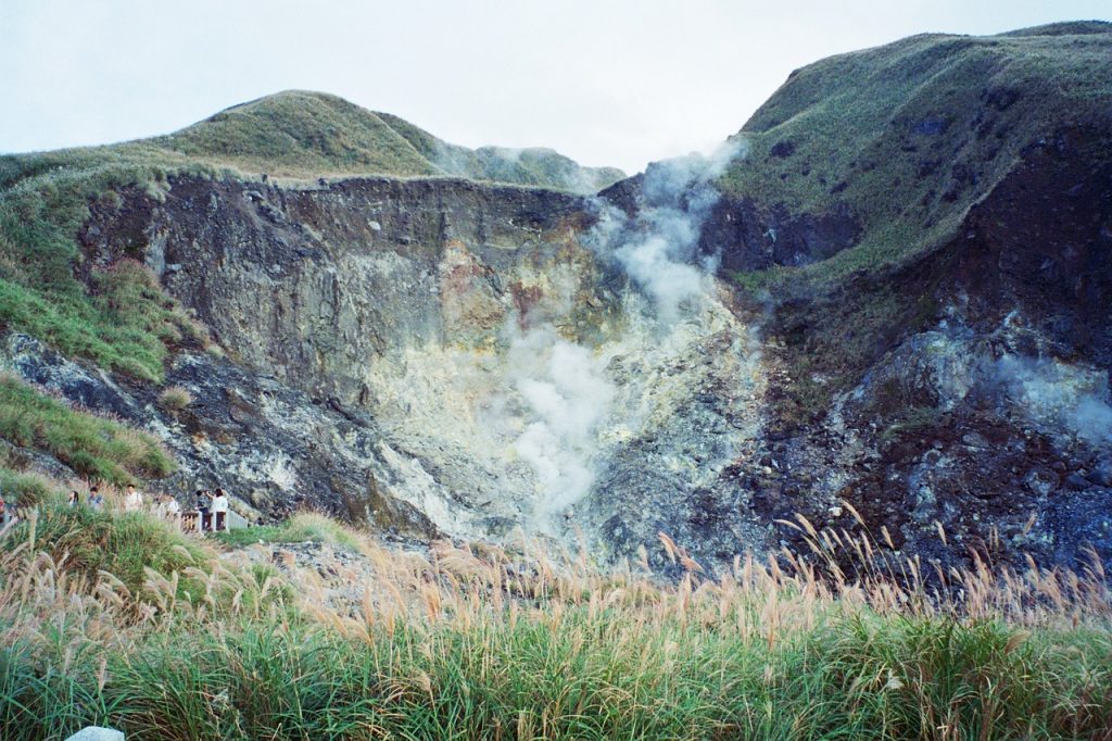 volcanic fumaroles in yangmingshan national park with smoke and steam rising from the ground