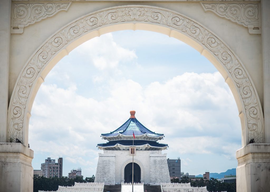 the beautifully framed pagoda of the building in the chiang kai-shek memorial hall area, in between the sides of an arch