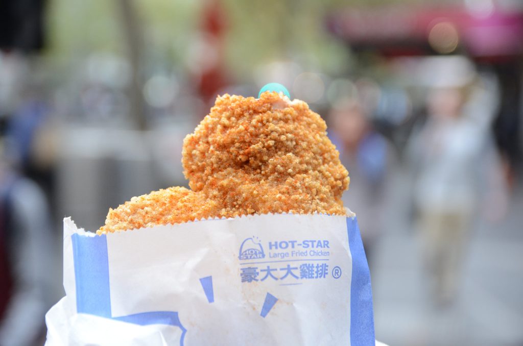 a piece of hot star fried chicken, a flat-pounded piece of chicken that is breaded, seasoned, and fried