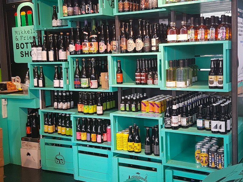 teal crates of beers crafted by the brewery mikkeller, one of the world's premier brewers