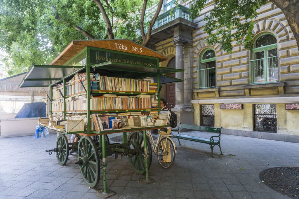 A cute little book cart in Budapest on a street