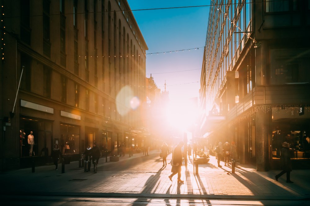 View of locals of Helsinki walking around and going about their day in the winter as the sun rises late in the morning