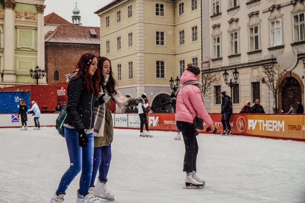 People ice skating on the rink in one of the main areas of Prague, a popular place for this winter activity when the rink is installed.