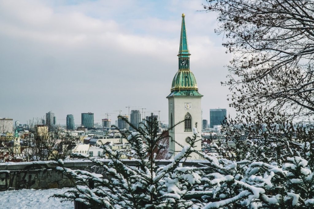 A turret of the castle area in Bratislava with a snow covered landscape all around