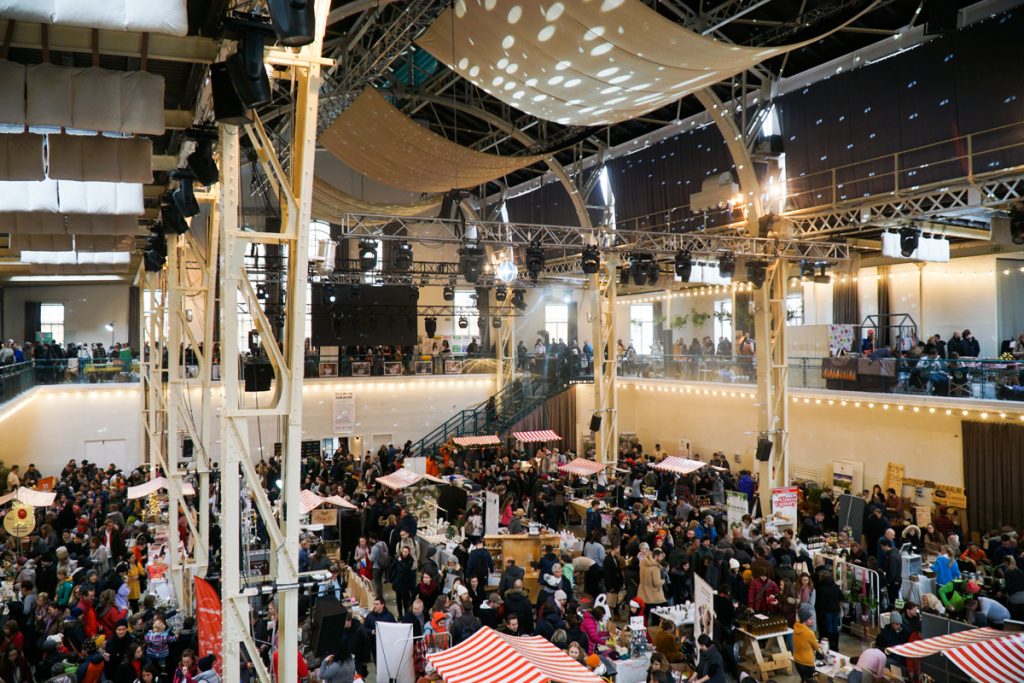 A crowded market hall in Slovakia that is covered with lots of small vendors inside.