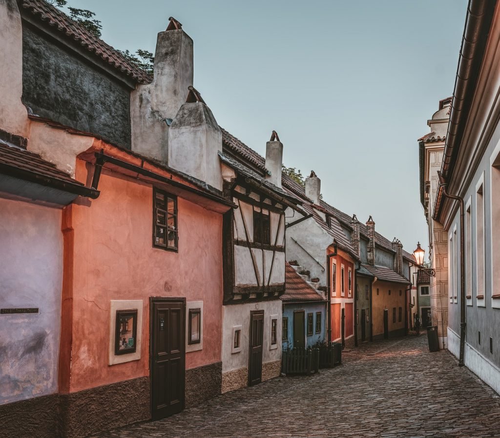 Houses in the dark atmosphere of a cloudy day in Prague, on the Golden Lane of old-fashioned houses in pastel colors that once belonged to artisans living in this area.