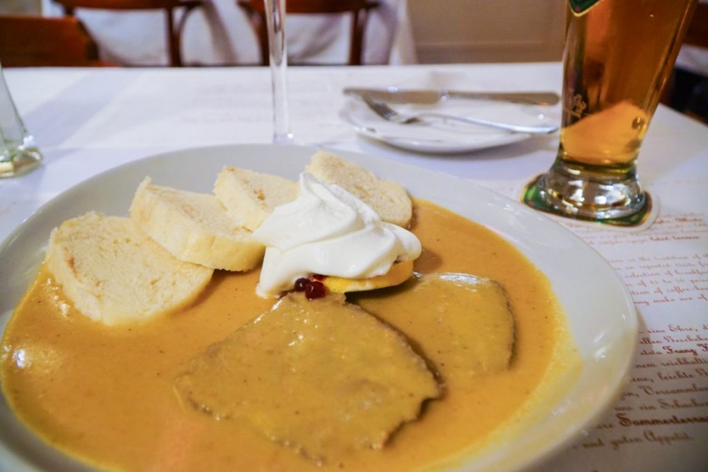 The traditional Czech dish of svichkova which is boiled beef with a parsnip sauce and boiled bread dumplings and jam