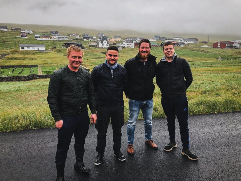 four local faroese men smiling for a photo