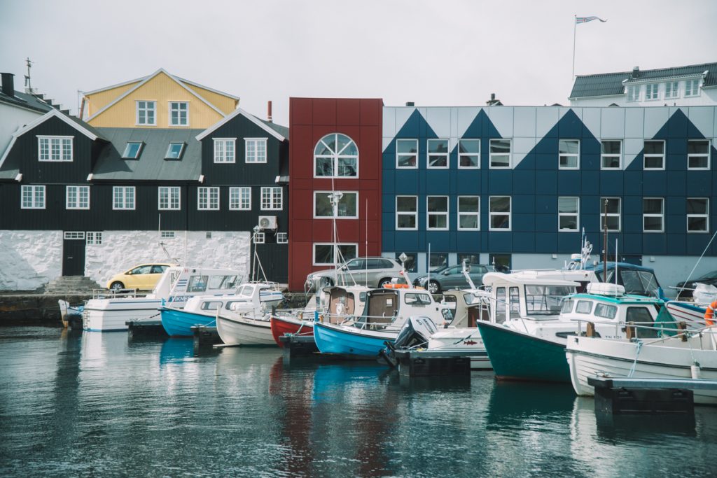 red, blue and black buildings in torhsavn harbor