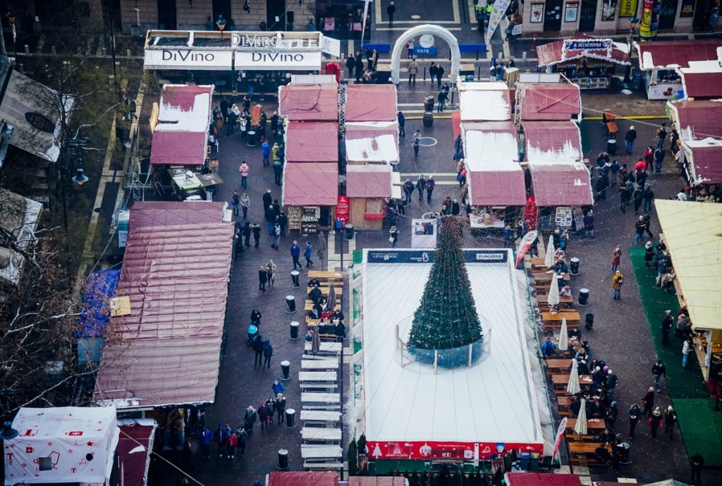 
View from above, from a church viewpoint, over the ice rink in the center of one of Budapest’s largest squares, with a Christmas tree in the middle of the ice rink