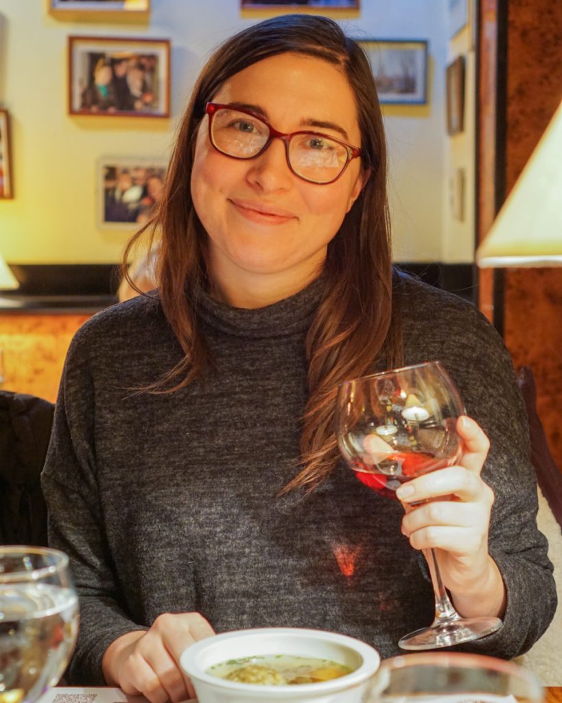 Allison in Budapest drinking a glass of wine