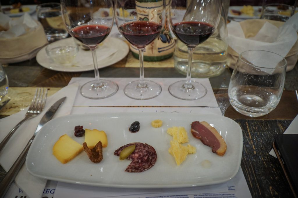 Three Hungarian red wines served with a sampling of cheeses, dried fruits, meats, etc. at a wine tasting class in Budapest in winter