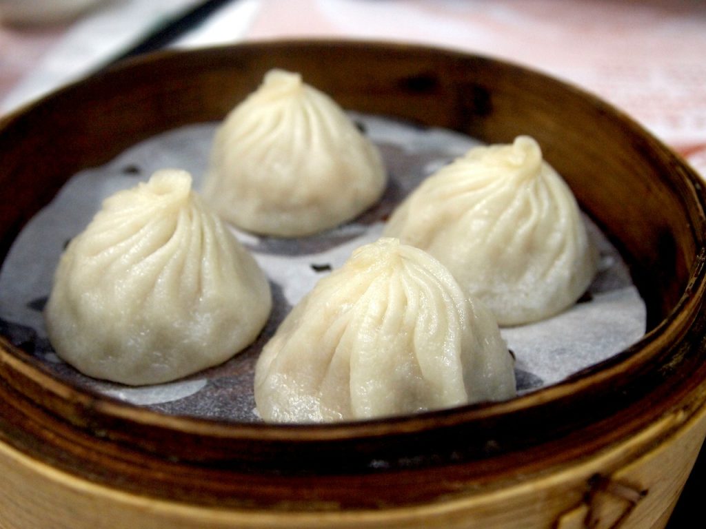 soup dumplings steamed in a bamboo steamer