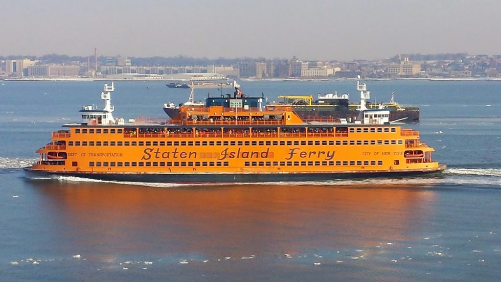 the bright orange staten island ferry in new york harbor