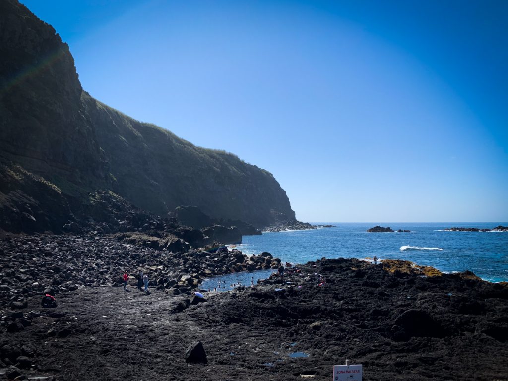 people enjoying the thermal waters in a natural pool in the azores sao miguel itinerary