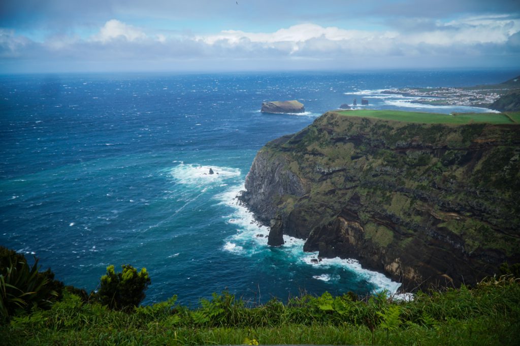 view of the rugged coastline of sao miguel from one of the many miradouros on the island, a must on any sao miguel itinerary