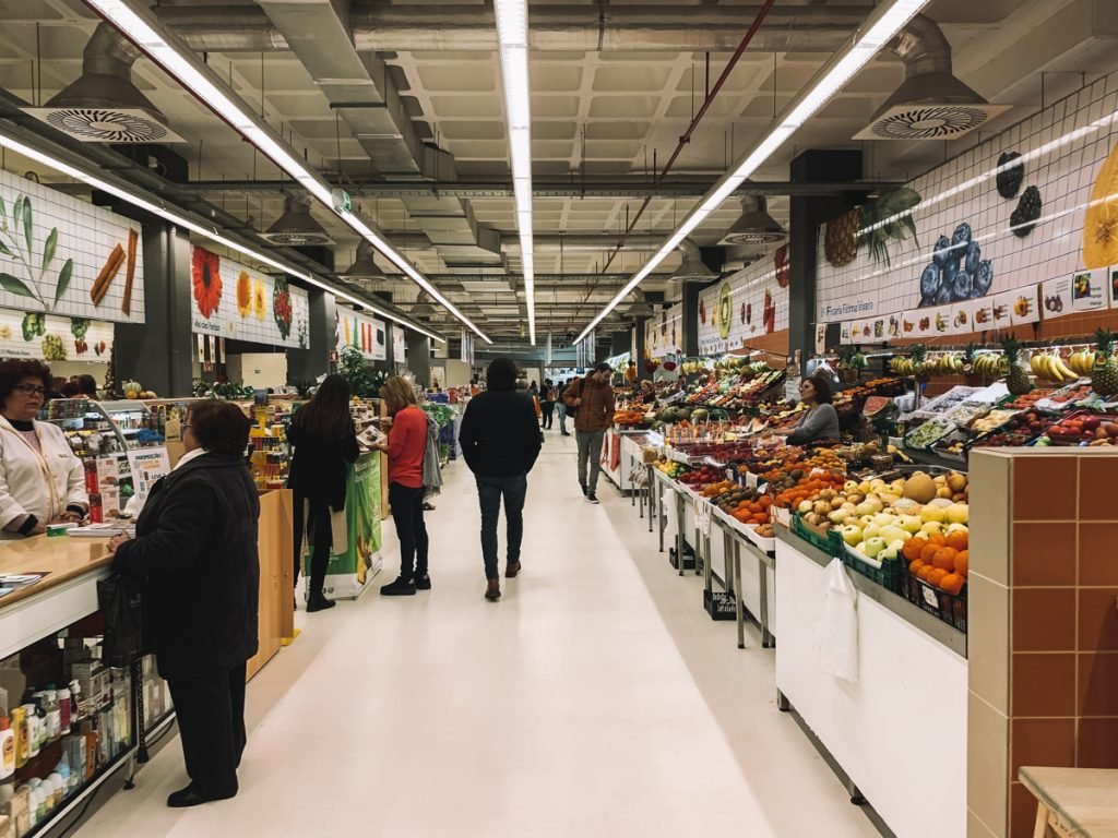 people walking in a produce market in porto