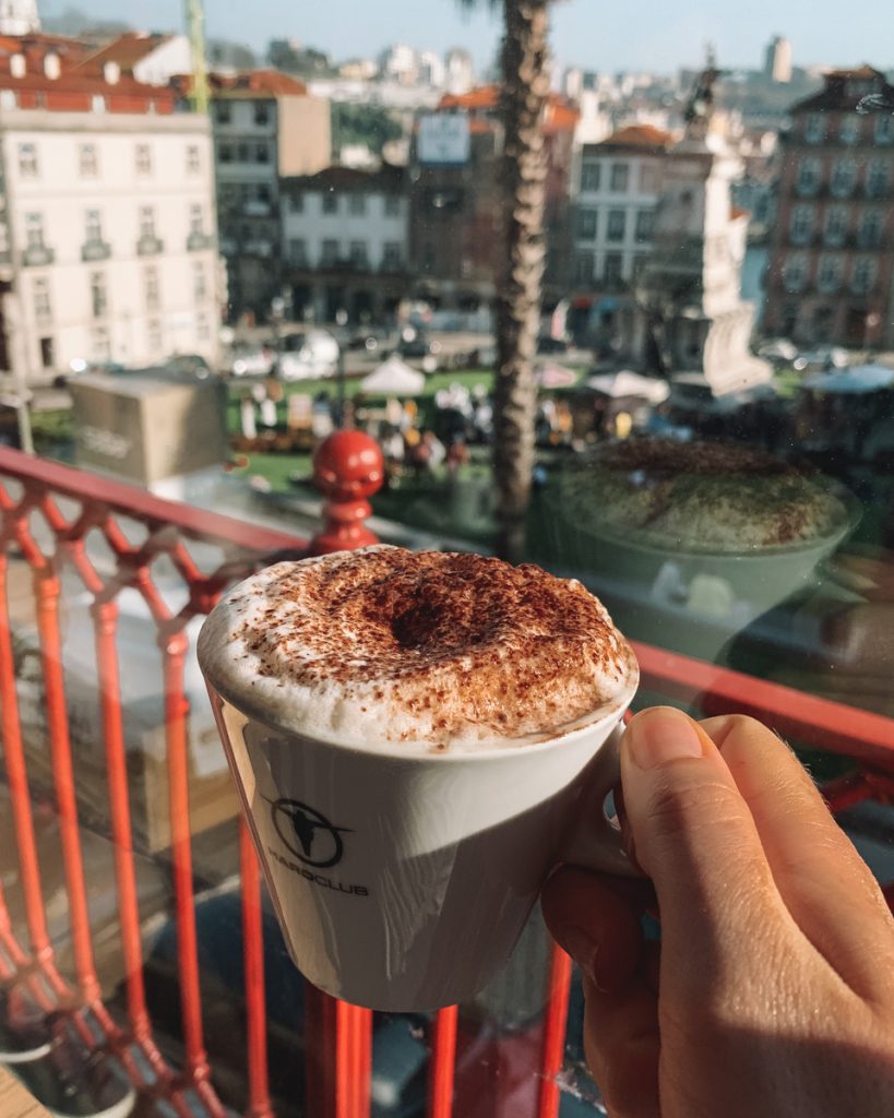 hand holding a cup of coffee in porto